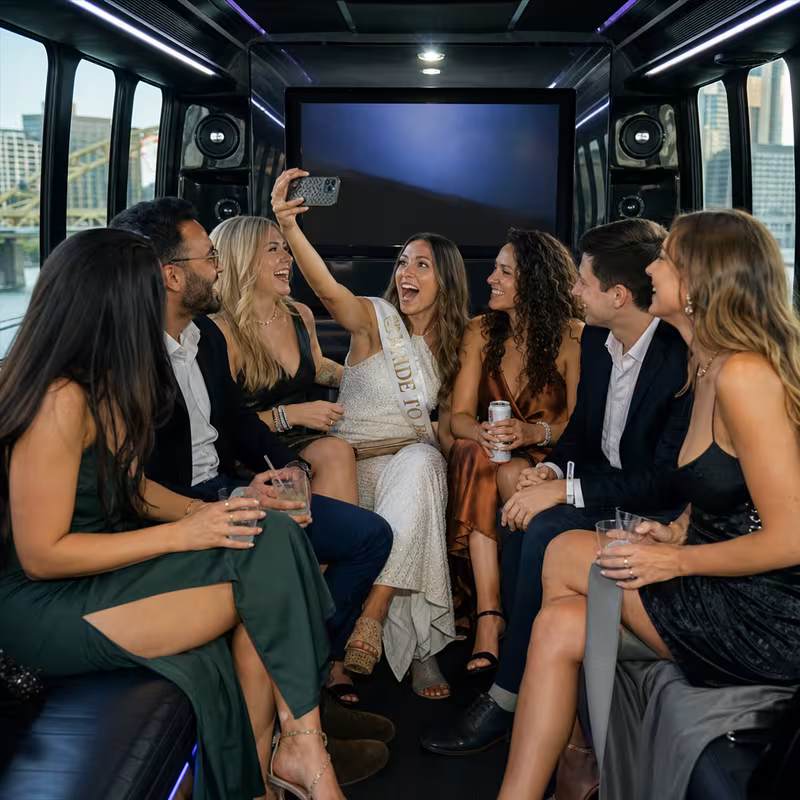 Party bus interior with wraparound leather seating and LED lighting in Pittsburgh