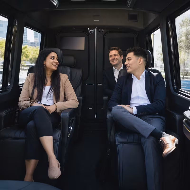 Group boarding a white charter bus for Corporate Transportation transportation in Pittsburgh