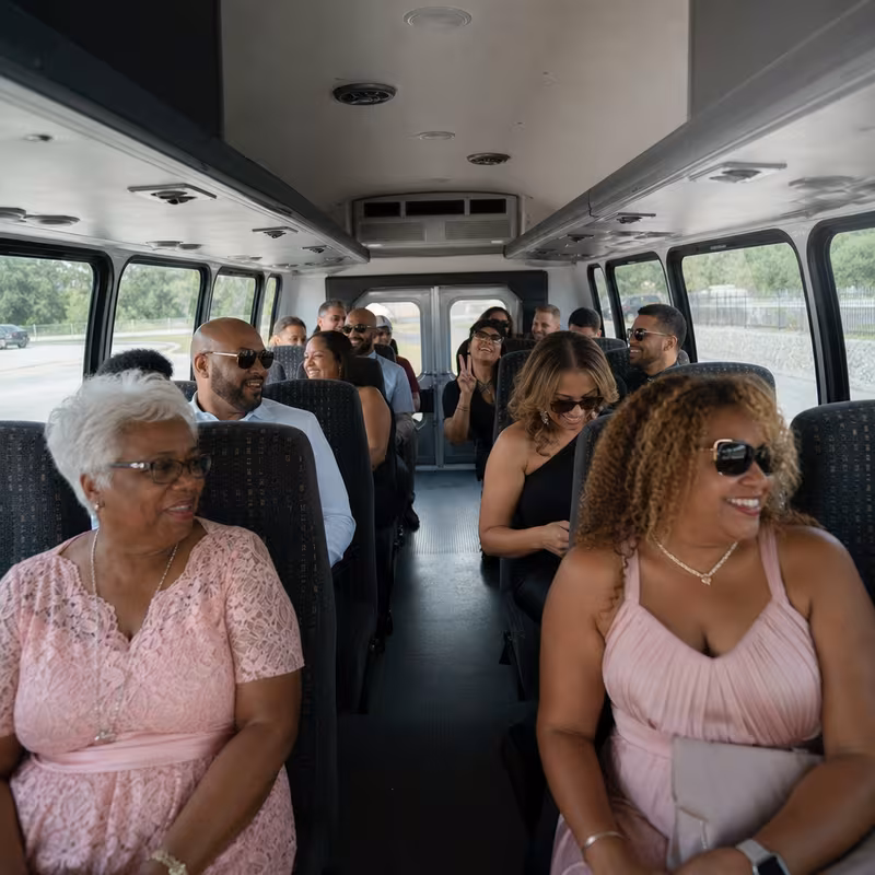 Group boarding a white charter bus for Private Event Transportation transportation in Pittsburgh