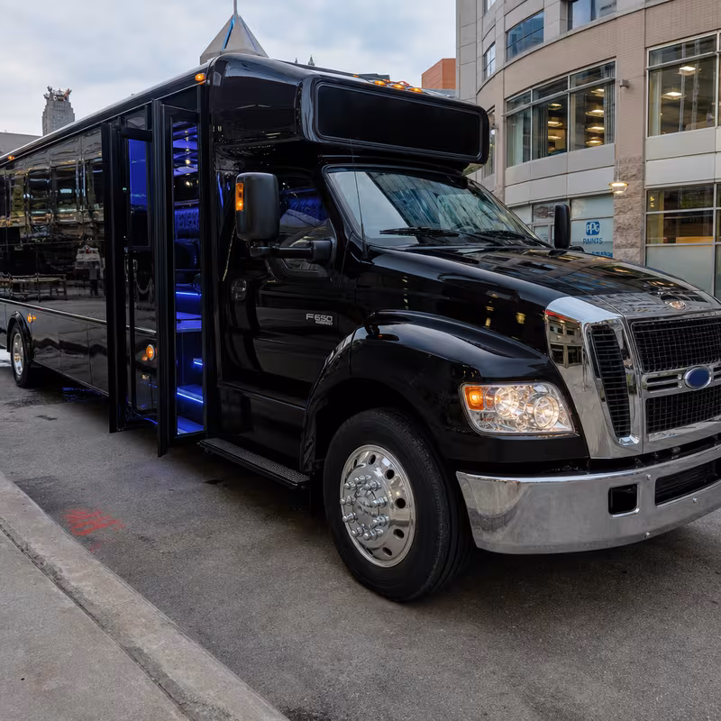 Party bus interior with wraparound leather seating and LED lighting in Pittsburgh