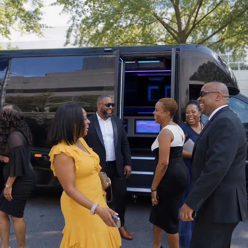 Passengers loading luggage while boarding an Pittsburgh group shuttle