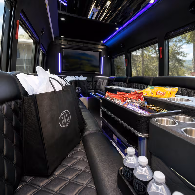 Party bus interior with wraparound leather seating and LED lighting in Pittsburgh